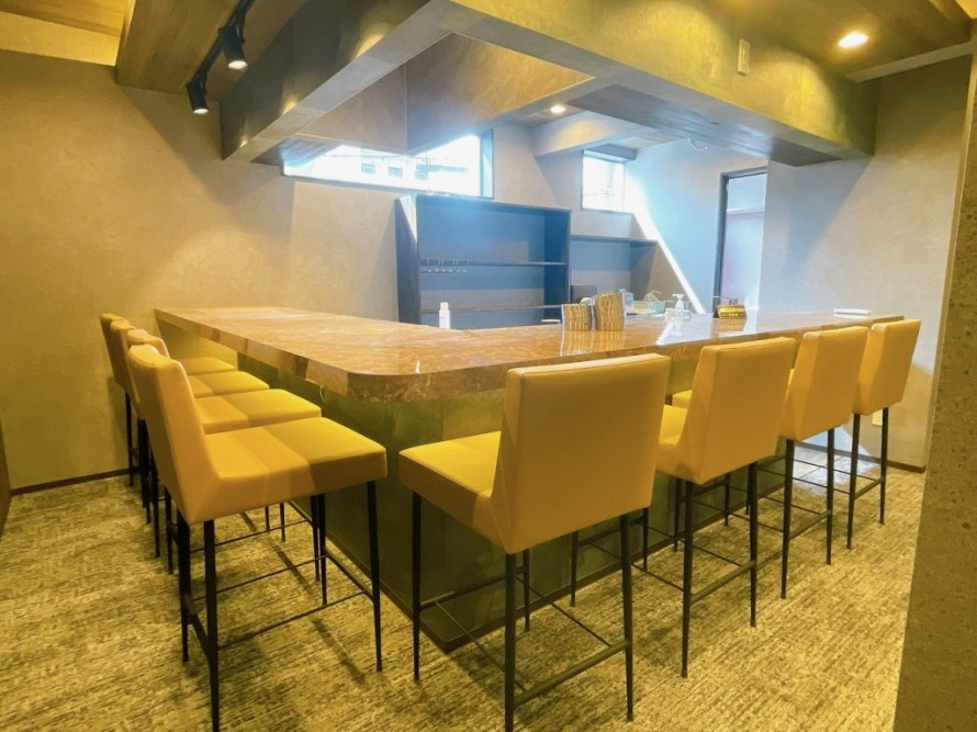 L字型バーカウンターが主役のバー内装デザイン。おしゃれな飲食店改装