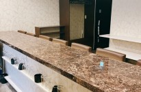 大理石調素材を使用したバーのバーカウンター内装。飲食店デザインの主役となる重厚なカウンター