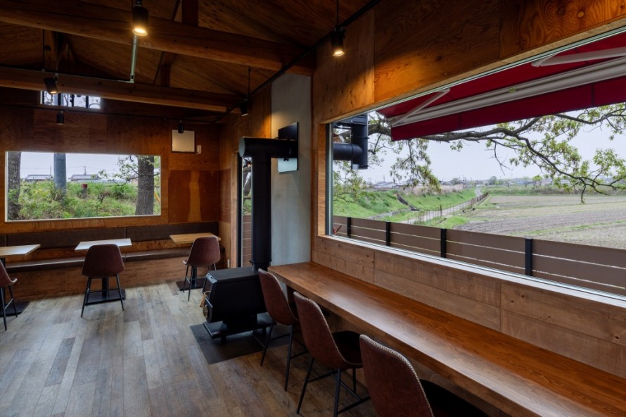 黒い薪ストーブが設置された隠れ家カフェの内装デザイン